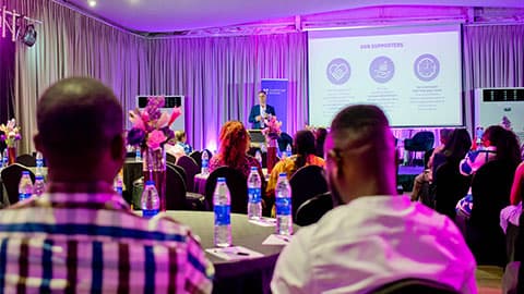 A shot of alumni from the back of a room looking at the panelists at an alumni reception in Lagos hosted by the University.